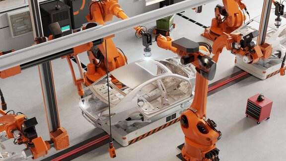 © iStockphoto/alvarez Robotic arms assembling a car frame in an automated factory, showcasing modern manufacturing technology